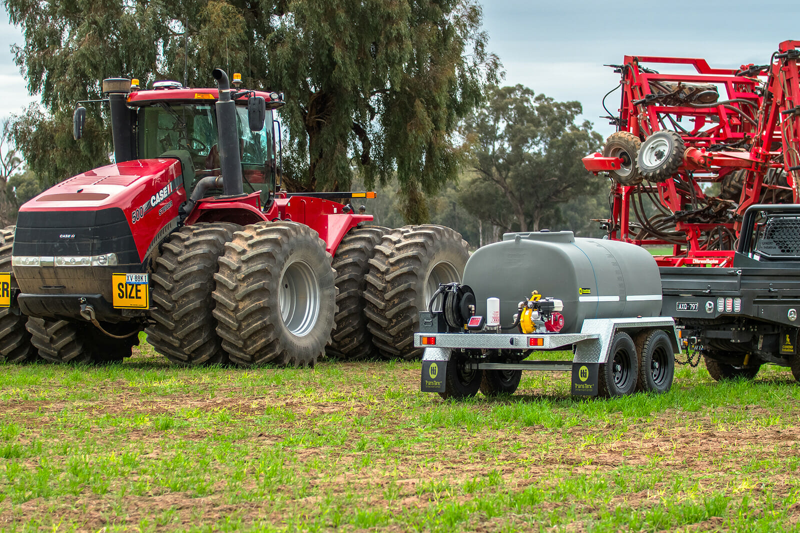 2000L DieselPatrol15™ Diesel Fuel Trailer and 2 farm trucks at the back