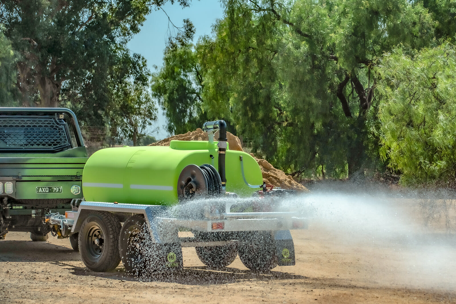 Fire Fighting Trailer attached to a pickup truck and releasing water