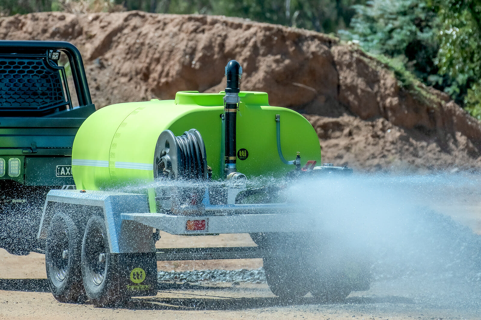 Fire Fighting Trailer attached to a pickup truck and releasing water