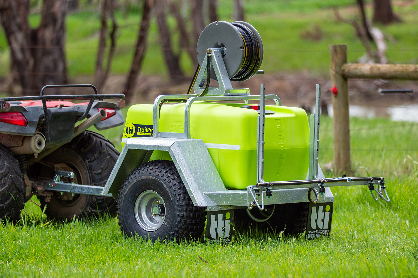 200L TrailPro™ 12v ATV Trailer Sprayer attached to an ATV