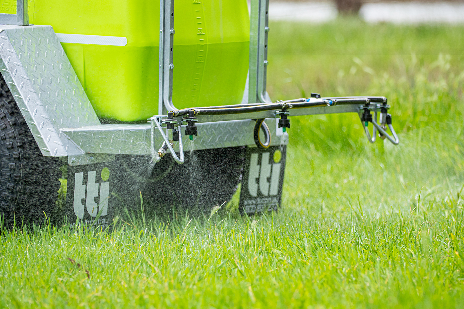 200L TrailPro™ 12v ATV Trailer Sprayer spraying water on plants